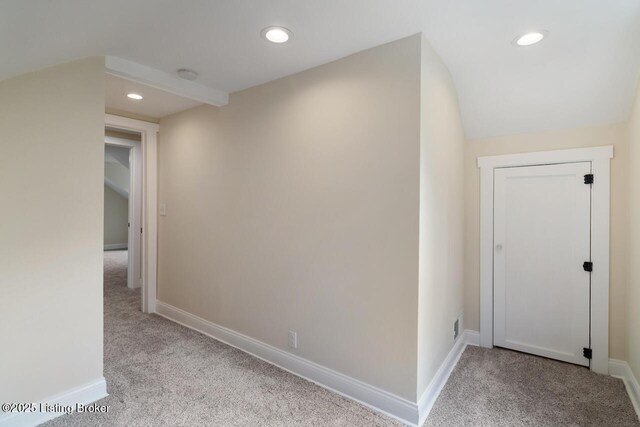 hallway with carpet floors, recessed lighting, and baseboards