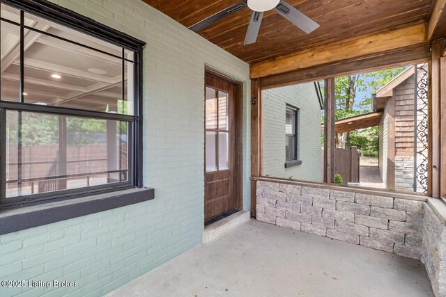 unfurnished sunroom with a ceiling fan