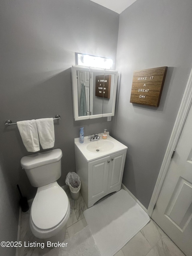 3115 Wynbrooke Cir, Louisville, KY 40241 - half bathroom with marble look tile flooring, toilet, vanity, and baseboards