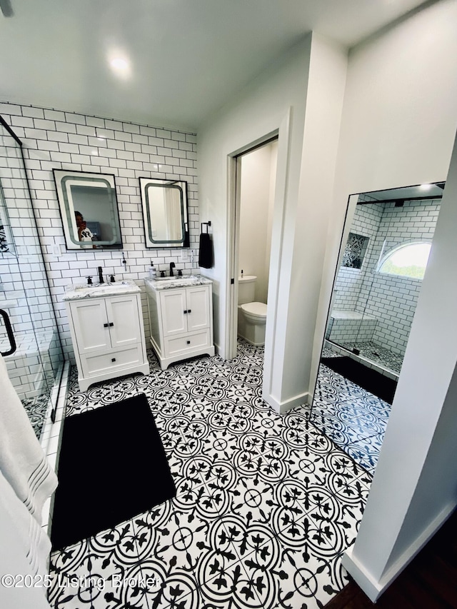 3115 Wynbrooke Cir, Louisville, KY 40241 - bathroom with tile patterned floors, two vanities, toilet, baseboards, and a stall shower