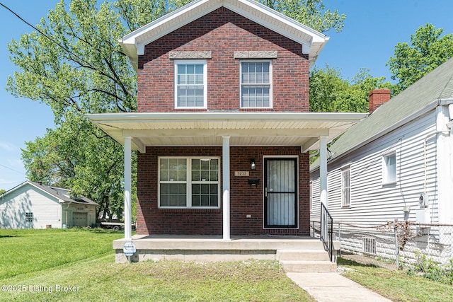 traditional-style house with a front yard, a porch, and brick siding