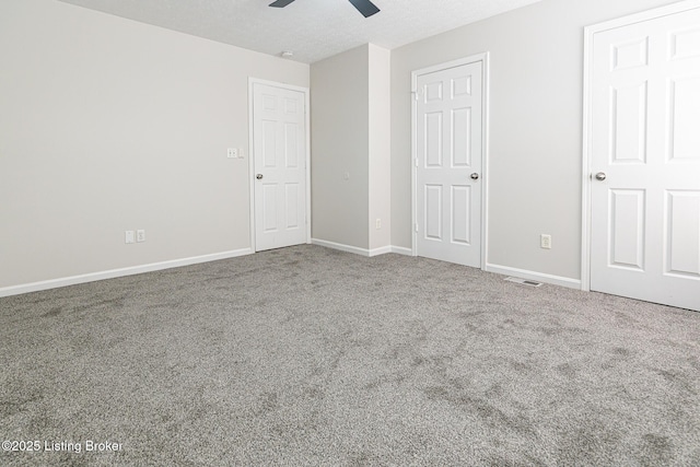 unfurnished bedroom with visible vents, carpet flooring, baseboards, and ceiling fan