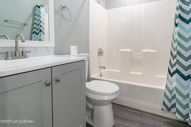 full bathroom with vanity, shower / bathtub combination with curtain, wood finished floors, and toilet