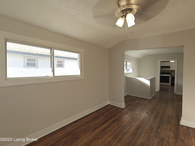 unfurnished room with lofted ceiling, baseboards, ceiling fan, a textured ceiling, and dark wood finished floors