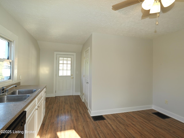 interior space featuring visible vents, dark wood finished floors, and baseboards