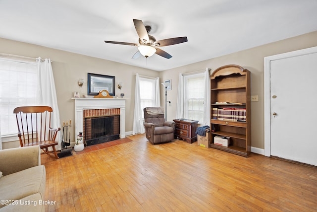 1042 Parkway Dr, Louisville, KY 40217 - living area featuring light wood-style floors, ceiling fan, visible vents, and a fireplace