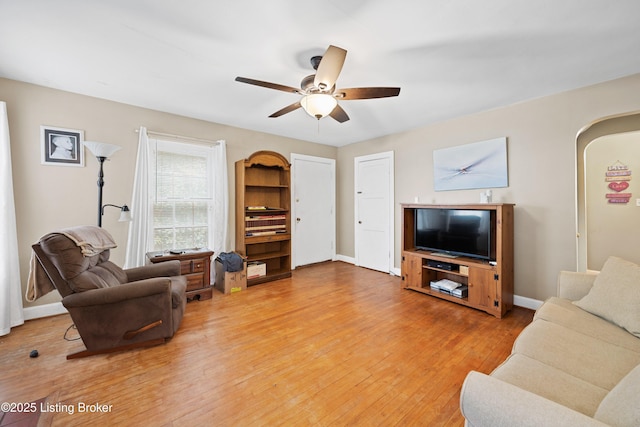 1042 Parkway Dr, Louisville, KY 40217 - living area with light wood-style floors, arched walkways, baseboards, and ceiling fan