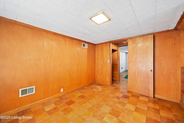 1042 Parkway Dr, Louisville, KY 40217 - unfurnished room with wooden walls, visible vents, and light floors