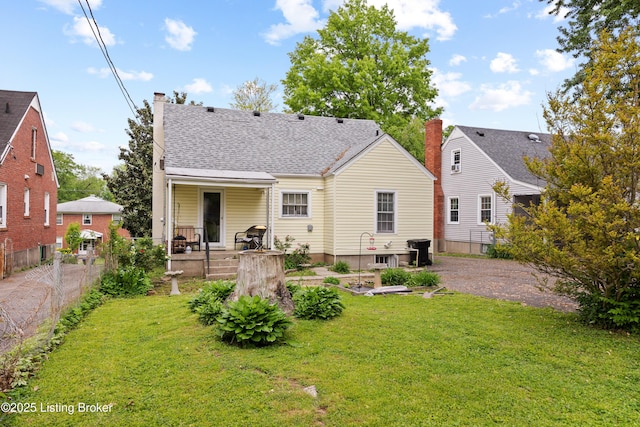 1042 Parkway Dr, Louisville, KY 40217 - back of property with a yard, fence, and a chimney