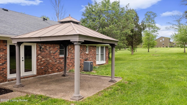 1614 W Reel Dr, La Grange, KY 40031 - property entrance with brick siding, a patio area, a yard, roof with shingles, and cooling unit