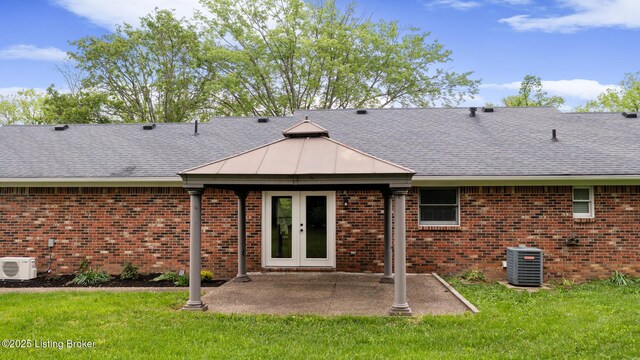 1614 W Reel Dr, La Grange, KY 40031 - rear view of house with a cooling unit, a shingled roof, a lawn, and brick siding