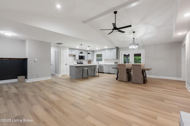 1614 W Reel Dr, La Grange, KY 40031 - kitchen with appliances with stainless steel finishes, a ceiling fan, light countertops, light wood-style floors, and a center island