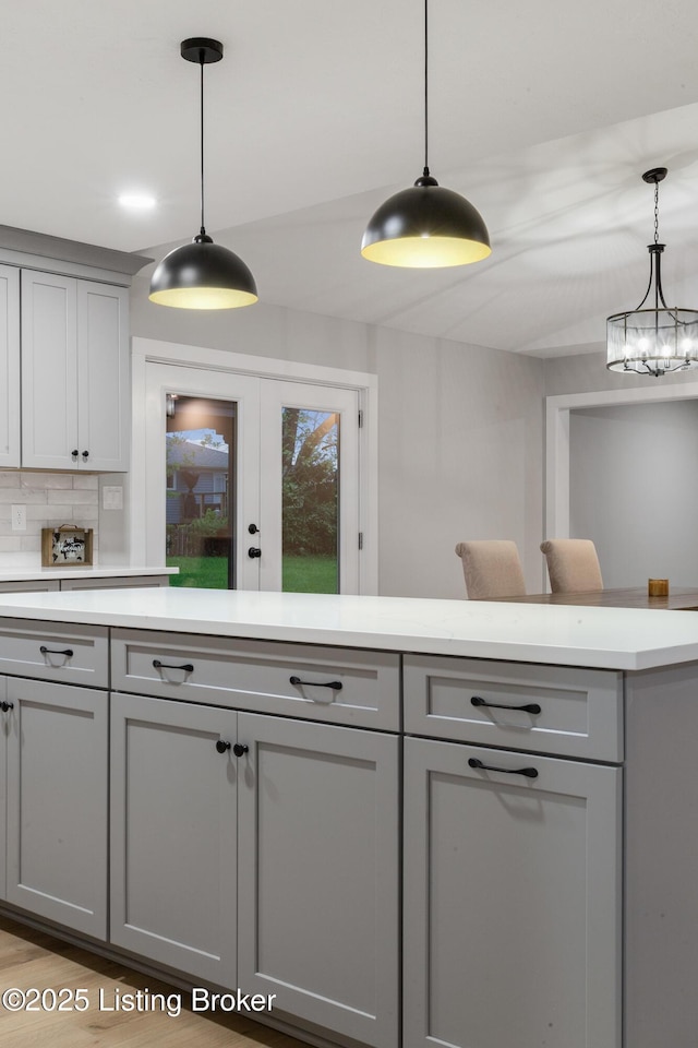 1614 W Reel Dr, La Grange, KY 40031 - kitchen featuring gray cabinetry, light countertops, backsplash, and pendant lighting