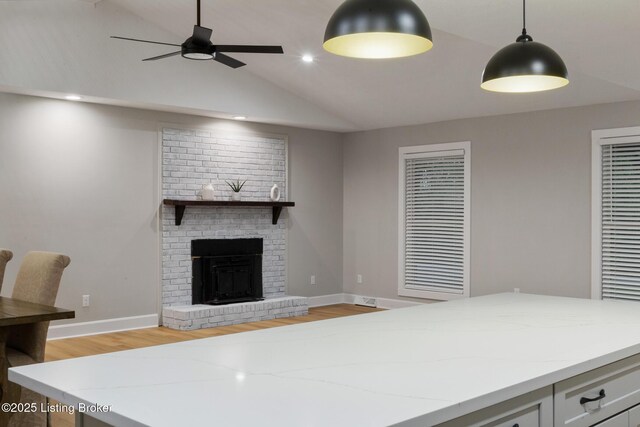 1614 W Reel Dr, La Grange, KY 40031 - living area featuring vaulted ceiling, light wood-type flooring, ceiling fan, a brick fireplace, and baseboards