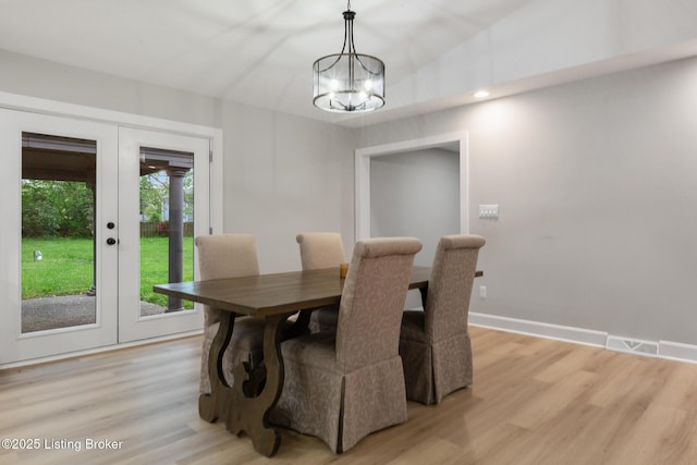 1614 W Reel Dr, La Grange, KY 40031 - dining area with french doors, light wood finished floors, a chandelier, and baseboards