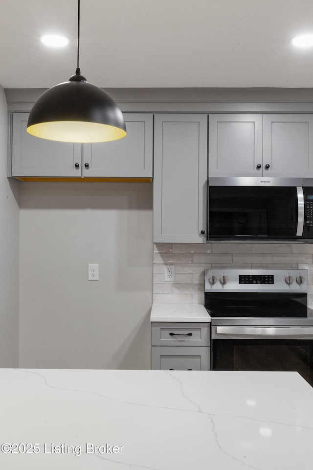 1614 W Reel Dr, La Grange, KY 40031 - kitchen featuring stainless steel appliances, gray cabinetry, tasteful backsplash, light stone counters, and decorative light fixtures