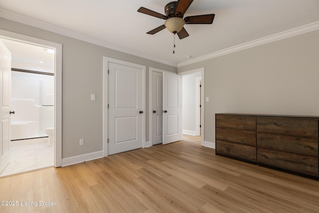 1614 W Reel Dr, La Grange, KY 40031 - unfurnished bedroom featuring crown molding, baseboards, light wood-style floors, connected bathroom, and multiple closets
