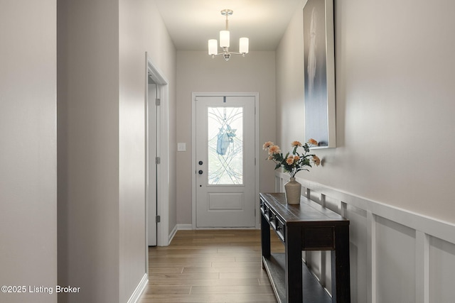 4107 Cobblestone Ln, La Grange, KY 40031 - entryway with light wood-style flooring, wainscoting, and a chandelier