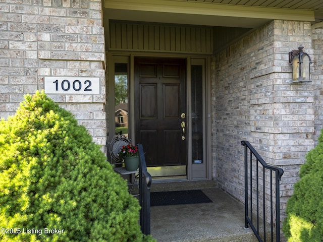 doorway to property with brick siding