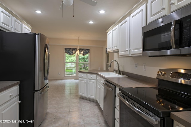 kitchen featuring a sink, white cabinets, stainless steel appliances, and recessed lighting