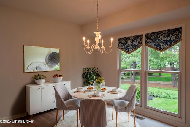 dining area featuring a notable chandelier and visible vents