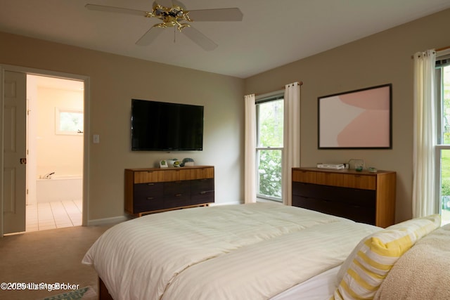 bedroom featuring baseboards, a ceiling fan, carpet, and multiple windows