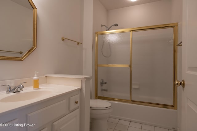 bathroom with vanity, enclosed tub / shower combo, tile patterned floors, and toilet