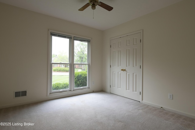 unfurnished bedroom featuring visible vents, carpet, baseboards, and a closet