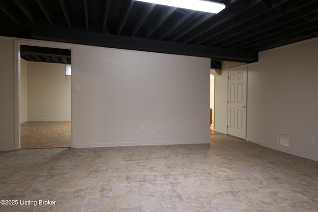 finished basement featuring baseboards and visible vents