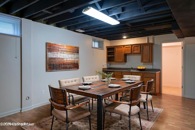 dining area with baseboards and wood finished floors
