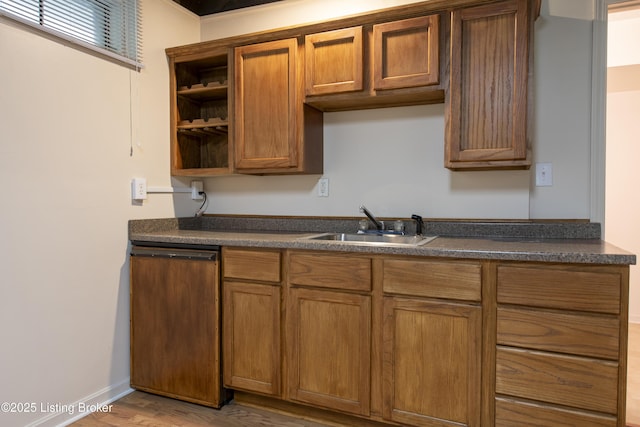kitchen with open shelves, a sink, dark countertops, and paneled dishwasher