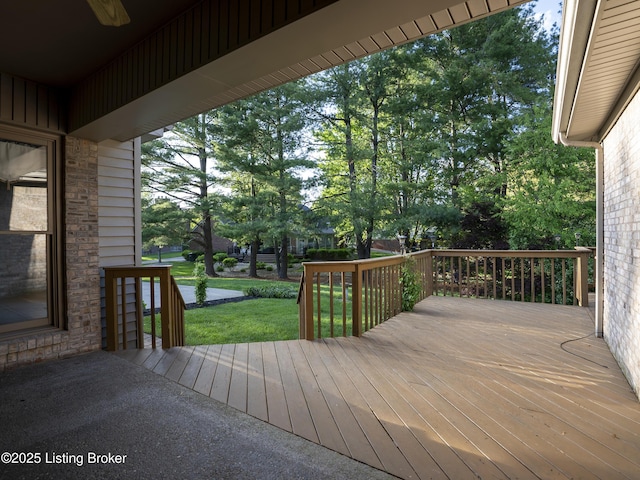wooden deck with a lawn