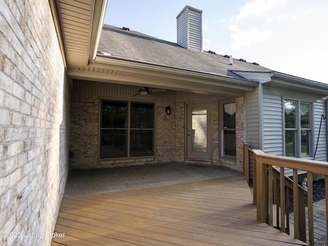 wooden terrace featuring a ceiling fan