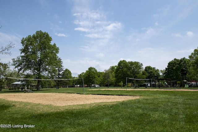 view of home's community with volleyball court and a yard
