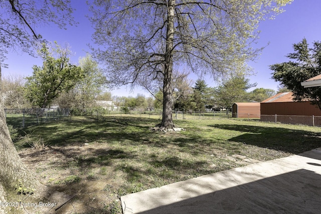 view of yard with an outdoor structure and fence