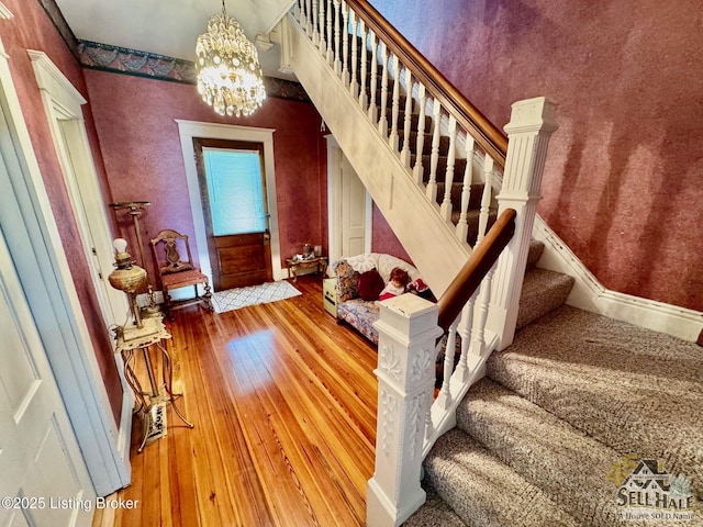 116 Lebanon Hl, Springfield, KY 40069 - stairway featuring wood-type flooring, baseboards, and a notable chandelier