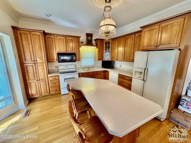 116 Lebanon Hl, Springfield, KY 40069 - kitchen featuring an inviting chandelier, white appliances, light countertops, brown cabinets, and hanging light fixtures