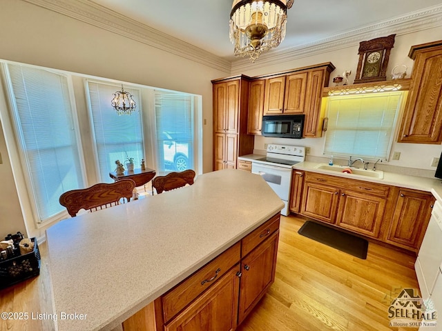 116 Lebanon Hl, Springfield, KY 40069 - kitchen with brown cabinetry, electric range, black microwave, a sink, and an inviting chandelier