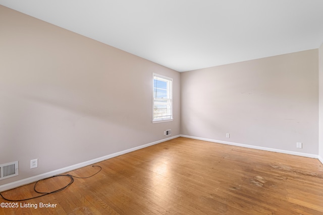 4605 S 3rd St, Louisville, KY 40214 - spare room featuring baseboards, wood finished floors, and visible vents