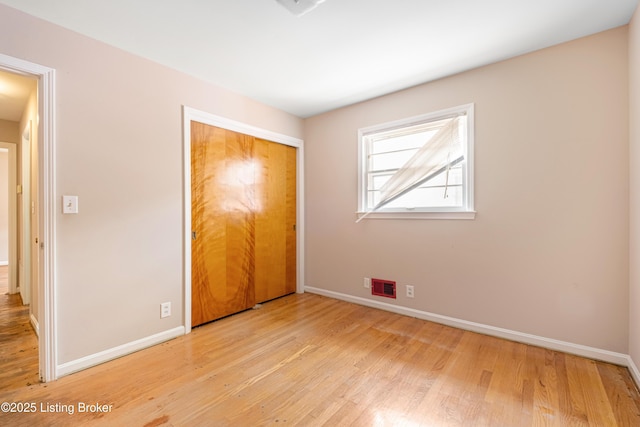 4605 S 3rd St, Louisville, KY 40214 - unfurnished bedroom with baseboards, visible vents, and wood finished floors