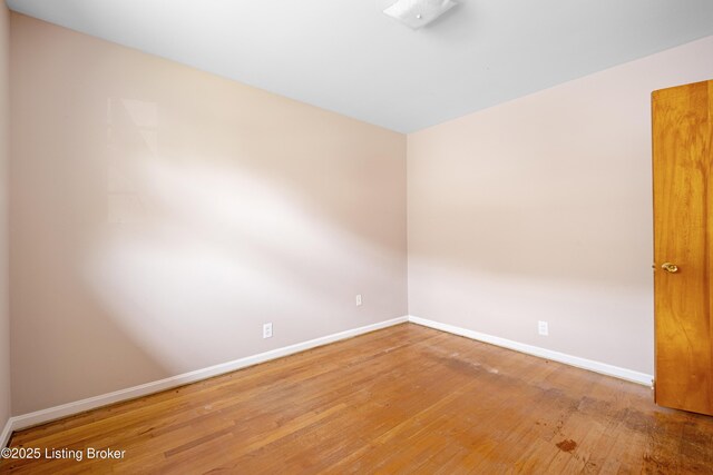 4605 S 3rd St, Louisville, KY 40214 - spare room with baseboards and hardwood / wood-style floors