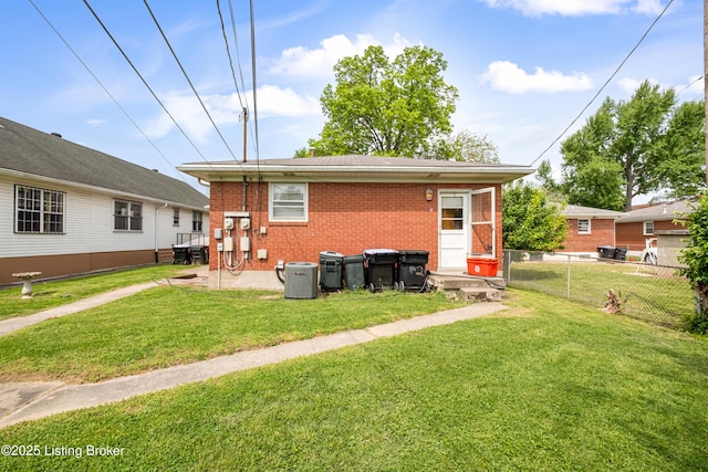 4605 S 3rd St, Louisville, KY 40214 - rear view of house featuring a lawn, brick siding, fence, and cooling unit
