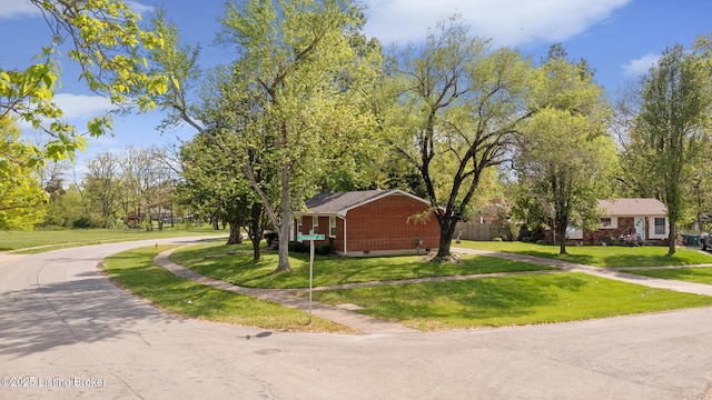 view of side of home with a yard