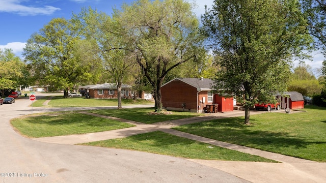 exterior space with brick siding and a front yard