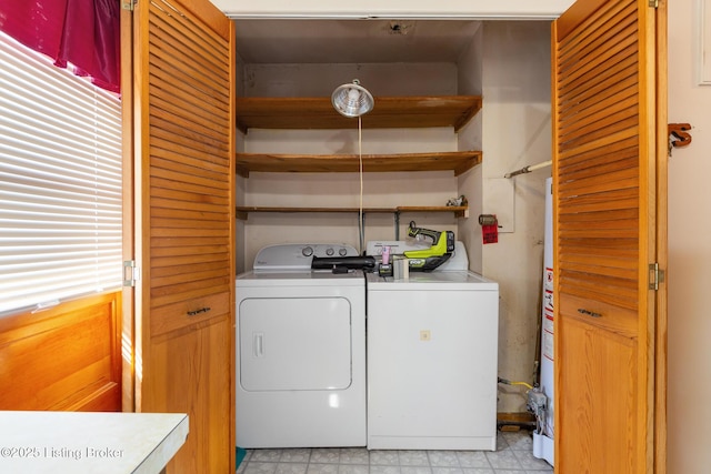washroom featuring washer and dryer, laundry area, and water heater