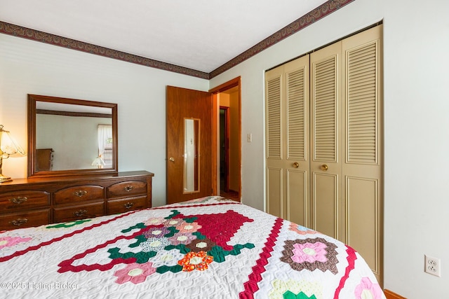 bedroom with ornamental molding and a closet