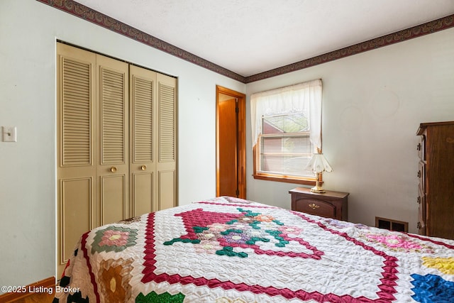 bedroom featuring baseboards, a closet, and visible vents