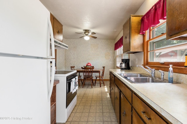 kitchen with ceiling fan, a sink, white appliances, light countertops, and extractor fan