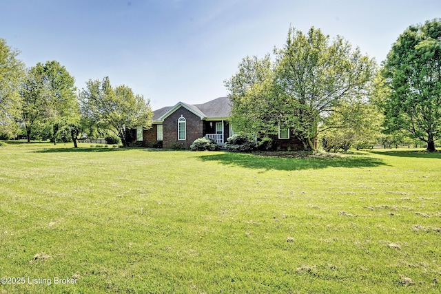 ranch-style house with brick siding and a front lawn