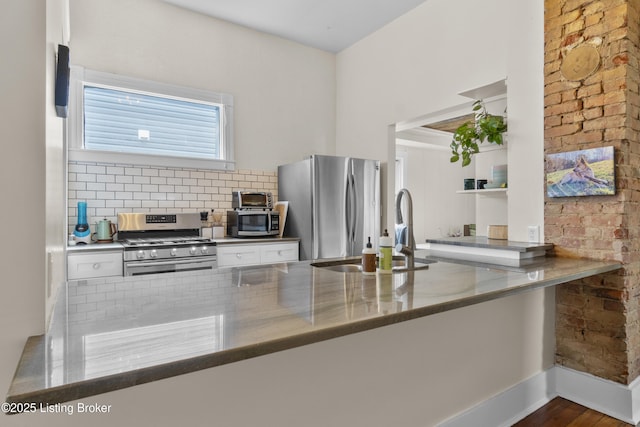 612 E Ormsby Ave, Louisville, KY 40203 - kitchen featuring stainless steel appliances, a sink, white cabinets, backsplash, and stone counters